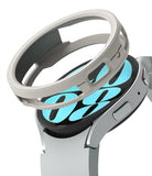 Galaxy Watch 6 44mm Case | Air Sports - A silver protective watch case hovering above a Galaxy Watch 6 with a blue dial.
