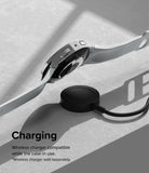 Galaxy Watch 6 44mm Case | Slim - A Galaxy Watch 6 with a slim case hovering above a black wireless charging puck.