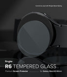 Galaxy Watch 6 44mm Screen Protector | Glass - R6 - Galaxy Watch 6 44mm Screen Protector - Tempered glass disc hovering over a black Galaxy Watch 6 on a dark background.