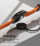 Galaxy Watch Ultra | Slim Extend & Glass - Smartwatch with orange band hovering over a wireless charging puck.
