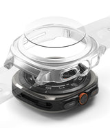 Galaxy Watch Ultra | Slim Extend & Glass - A clear protective case and screen protector hovering above a Galaxy Watch Ultra.