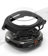 Galaxy Watch Ultra | Slim Extend & Glass - Exploded view of a black protective watch case and glass screen protector above a Galaxy Watch Ultra.