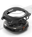 Galaxy Watch Ultra | Slim Extend & Glass - Exploded view of a black protective watch case and screen protector above a Galaxy Watch Ultra.