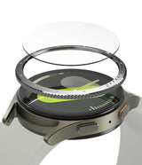 Galaxy Watch 7 (44mm) | Bezel Styling & Glass - Exploded view of a smartwatch with a metal bezel ring and glass protector.