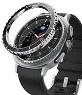 Galaxy Watch 8 Classic 46mm | Bezel Styling Premium - A metallic bezel ring hovering above a smartwatch with a black leather strap and moon dial.
