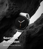 Galaxy Watch 9 / 8 44mm Case | Slim - A smartwatch with a white band and black round face is nestled between dark rock formations. Large white text at the bottom reads 'Seamless Protection' with smaller text 'Blocks scratches and dust.