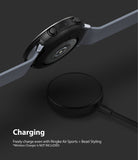 Galaxy Watch Active 2 (44mm) | Air Sports Black + Bezel Styling - Smartwatch with protective case hovering over a charger.