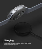 Galaxy Watch Active 2 (44mm) | Air Sports Matte Clear + Bezel Styling - Smartwatch with clear case hovering over charger.