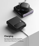 Galaxy Z Flip 3 Case | Slim - Black case on a wireless charger with Galaxy Buds Pro resting on a second folded phone.