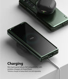 Galaxy Z Fold 3 Case | Slim - Folded phone in green case wirelessly charging with earbuds on top showing 100% battery.