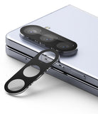 Galaxy Z Fold 5 | Camera Protector Glass [2 Pack] - A black camera lens protector being applied to a silver smartphone.