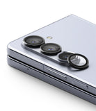 Galaxy Z Fold 5 | Camera Lens Frame Glass - Galaxy Z Fold 5 - Black protective glass rings installed over the camera lenses of a silver foldable smartphone.