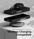 Galaxy Z Fold 5 Case | Slim - Folded phone in black case charging wirelessly on a pad with earbuds case on top.