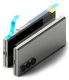 Galaxy Z Fold 6 Screen Protector | Hinge Dual Easy Film - Galaxy Z Fold 6 Screen Protector - Hinge film being applied to a folded silver smartphone with blue alignment tabs.