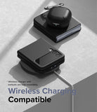 Galaxy Z Flip 4 Case | Slim - Black Galaxy Z Flip 4 in a slim case and earbuds case resting on a wireless charging pad.