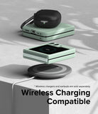 Galaxy Z Flip 5 Case | Slim Color - Mint green phone case on a wireless charger with black earbuds on top.