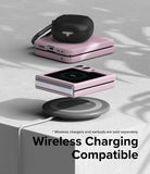 Galaxy Z Flip 5 Case | Slim Color - Pink Galaxy Z Flip 5 case on a wireless charger with earbuds on top.
