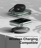 Galaxy Z Flip 5 Case | Slim Hinge - Clear - Folded phone in clear case wirelessly charging with earbuds on top.