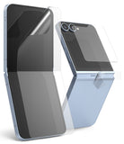 Galaxy Z Flip 6 | 3-in-1 Protector - Light blue phone with transparent screen, back, and hinge protective films being applied.