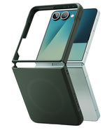 Galaxy Z Flip 7 Case | Onyx Magnetic - A dark green magnetic case partially fitted onto a silver Galaxy Z Flip 7.
