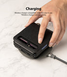 Galaxy Z Flip Case | Folio Signature Black - A hand places a black leather Galaxy Z Flip case onto a wireless charger.
