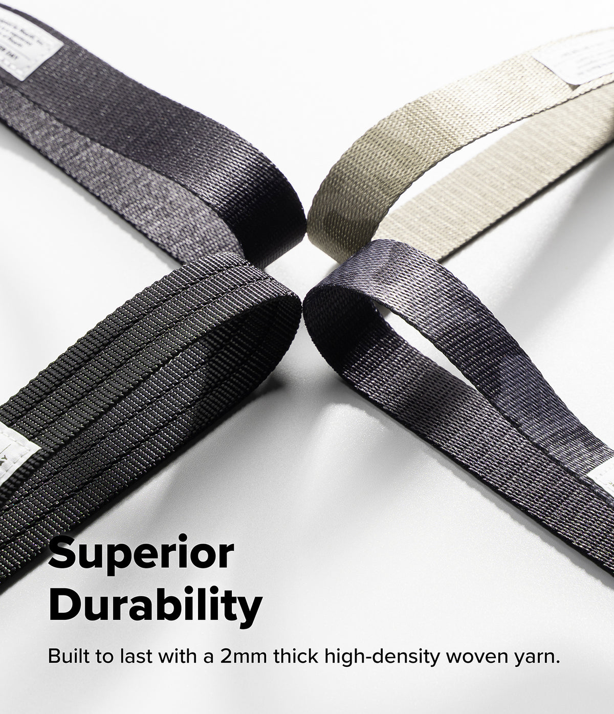 Holder Link Tactical Cam Buckle Hand Strap - Four woven webbing straps in black, gray, and off-white, arranged in a star-like pattern on a white background with the text 'Superior Durability' and 'Built to last with a 2mm thick high-density woven yarn.'.