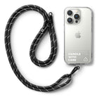 Holder Link Strap | Clear - Black braided rope lanyard with metal clips attached to a clear phone case with white text.