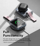 Galaxy Z Flip 6 / 5 / 4 / 3 | Hinge Cover - Folded phone with hinge cover and pink strap charging wirelessly on a pad.