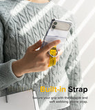Galaxy Z Flip 7 FE / 6 / 5 / 4 / 3 | Hinge Cover Tarpaulin - Galaxy Z Flip 7 FE / 6 / 5 / 4 / 3 | Person holding a phone with a yellow "DANGER" warning strap and metal ring.