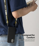 iPhone 12 Mini Case | Air-S - Black phone case hanging from a yellow and black branded lanyard worn over the shoulder.