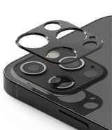 iPhone 12 Pro | Camera Styling - A black protective lens cover hovering above the triple-camera array of a dark iPhone.