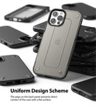 iPhone 12 / 12 Pro Case | [UX] - A translucent phone case with protective rear pegs stacked among several black phone cases.