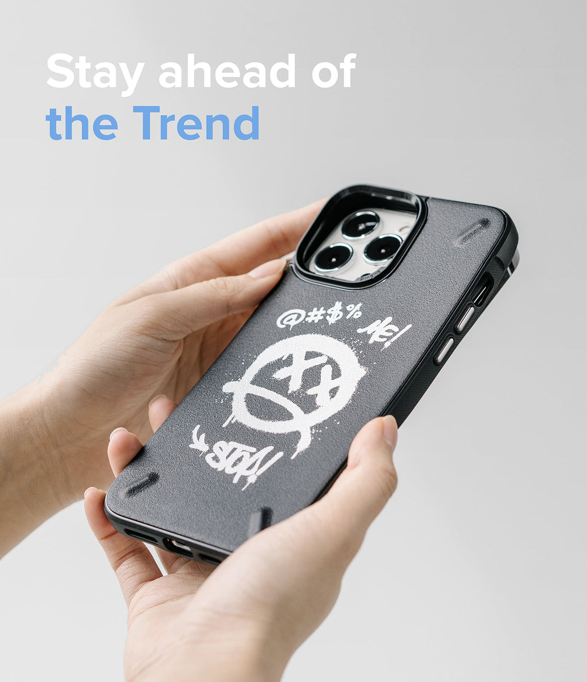 iPhone 13 Pro Max Case | Onyx Design - Hands holding a black phone case with white graffiti-style art and text.