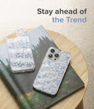 iPhone 13 Pro Case | Fusion Design - Two clear floral phone cases resting on a forest-themed book atop a wooden stool.