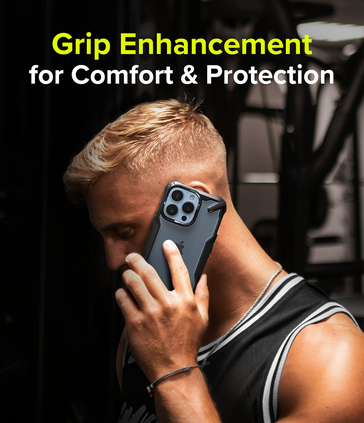 iPhone 13 Pro Case | Fusion-X - Man in a gym holding a black Fusion-X phone case to his ear with text overlay about grip.