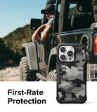 iPhone 14 Pro Max Case | Fusion-X - Black camouflage phone case with rugged bumpers shown next to a person in a Jeep.
