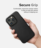 iPhone 14 Pro Max Case | Onyx - Hand holding a black textured phone case with a triple-lens camera cutout against a white background.