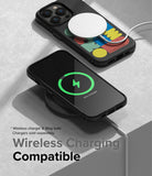 iPhone 14 Pro Max Case | Onyx Design - Black phone case with colorful geometric art charging wirelessly on a desk.