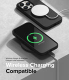 iPhone 14 Pro Case | Silicone - Black iPhone 14 Pro in a silicone case charging wirelessly with a MagSafe puck and charging pad.