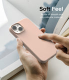 iPhone 14 Case | Silicone - Hand holding a smooth, light pink silicone iPhone 14 case with text reading Soft Feel.