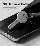 iPhone 15 Pro Max Screen Protector | Privacy Glass - A metal key resting on a smartphone screen protector with 9H hardness text.
