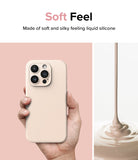 iPhone 15 Pro Max Case | Silicone Magnetic - Hand holding a beige silicone phone case next to pouring liquid.