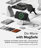 iPhone 15 Plus Case | Fusion-X Magnetic Matte Black - iPhone 15 Plus in a black case charging on a stand with various MagSafe accessories arranged on a white surface.