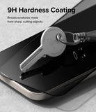 iPhone 15 Plus Screen Protector | Privacy Glass - A metal key resting on a smartphone screen with 9H hardness coating.