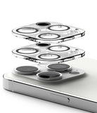 iPhone 15 Pro | Camera Protector Glass [2 Pack] - Two transparent lens protectors hovering above an iPhone 15 Pro camera.