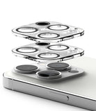 iPhone 15 Pro Max | Camera Protector Glass [2 Pack] - iPhone 15 Pro Max | Camera Protector Glass - Two transparent glass lens protectors hovering above an iPhone camera array.