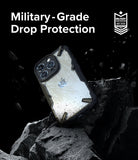 iPhone 15 Pro Case | Fusion-X - Protective phone case resting on jagged rocks with floating debris and military-grade text.