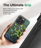iPhone 15 Pro Case | Onyx Design - Hand holding a black phone case with a neon paint splatter pattern and textured micro-dot sides.