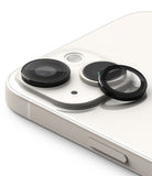 iPhone 15 Plus / 15 | Camera Lens Frame Glass - iPhone 15 Plus / 15 - Camera lens protector being applied to the dual-lens array of a white iPhone.
