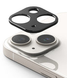 iPhone 15 Plus / 15 | Camera Styling - iPhone 15 Plus / 15 Camera Styling - A black protective lens cover hovering above the dual-camera array of a white iPhone.